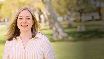Person standing outdoors in a park setting