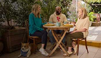 People seated outdoors at a table together